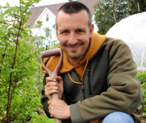 Man kneeling with a shovel