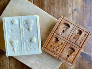 Square butter with flower designs on top from a mold