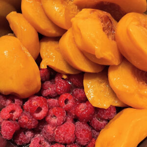 Peaches and raspberries ready to be cooked down into jam