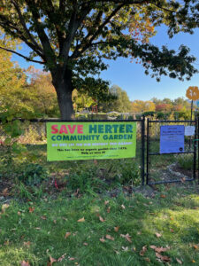 A banner on the gate of the garden reads