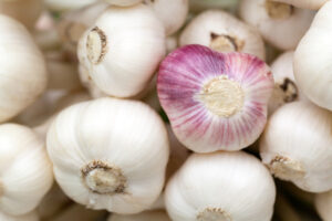 A close up of garlic cloves in a pile