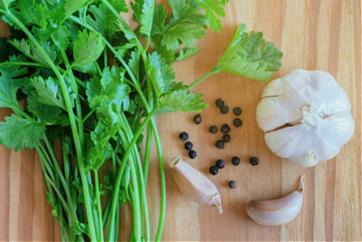 Left to right: Fresh cilantro leaves, cilantro seeds, garlic cloves.