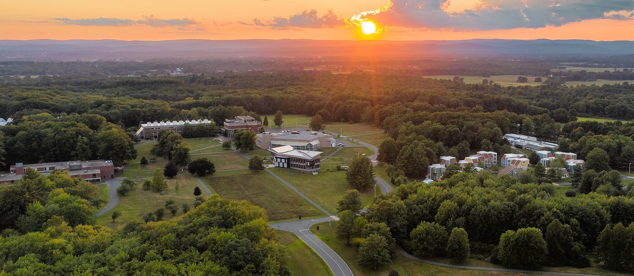 An aerial view of the Hampshire college campus at sunset