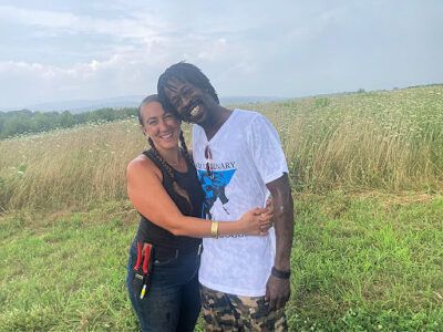 Two people hugging in a field