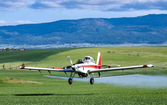 Airplane emission over green field